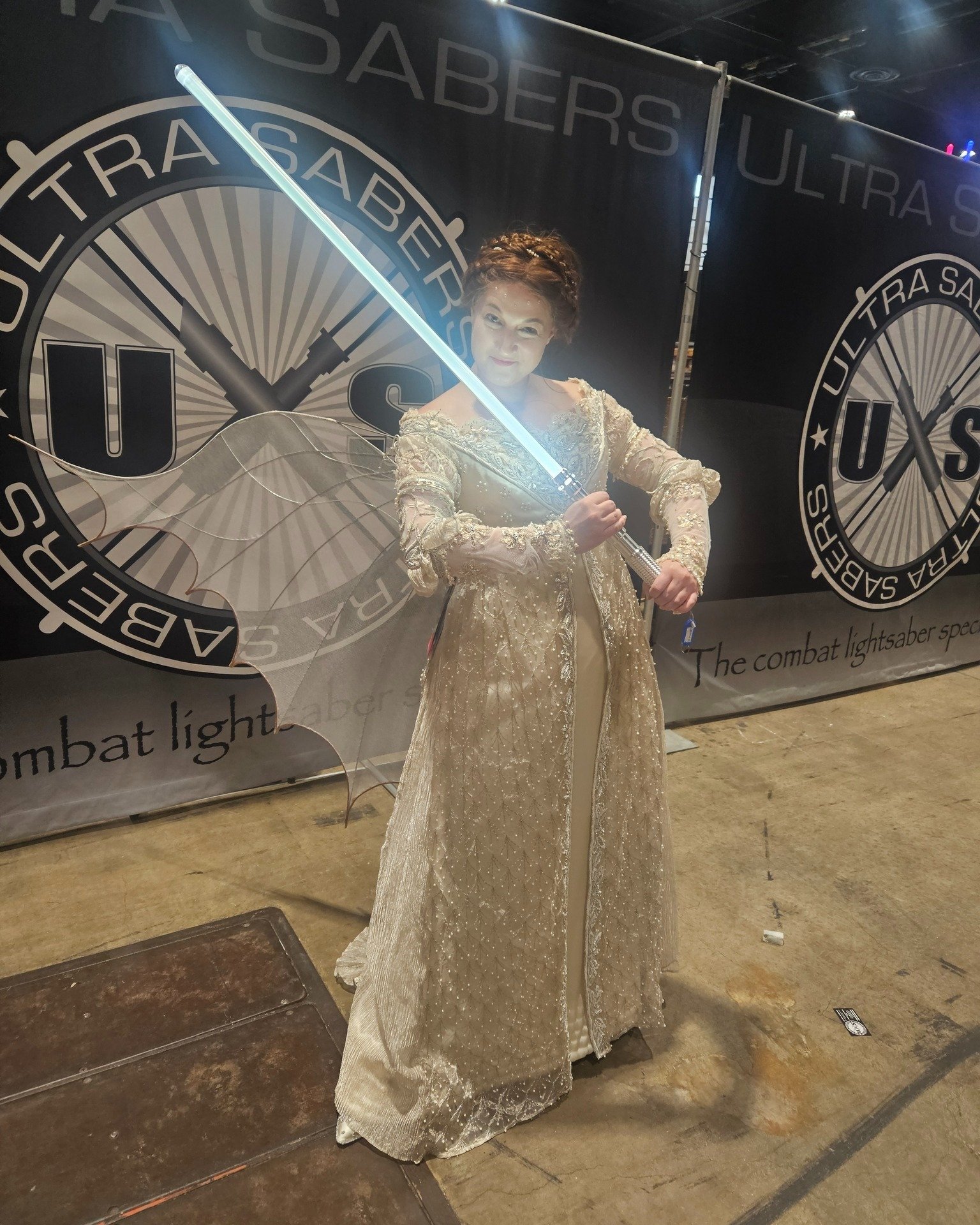 A break from our Good Omens feature to say May the 4th be with you with a photo of Danielle visiting to the Ultra Sabers booth at C2E2 2024.

#lightsaber #everaftercosplay #ultrasabers